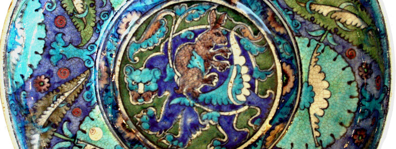 An intricate decorative dish in hues of blue, purple and green.