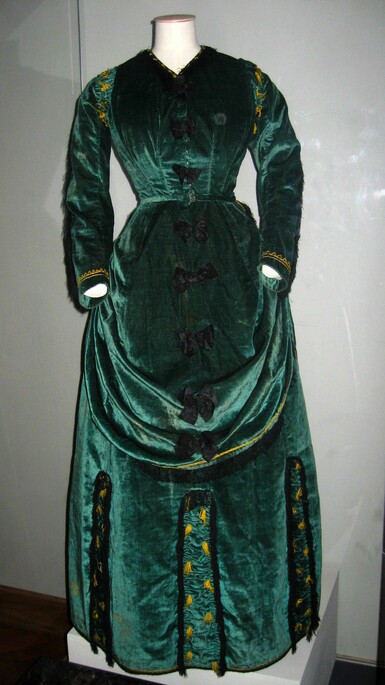 A green velvet full-length dress on a mannequin