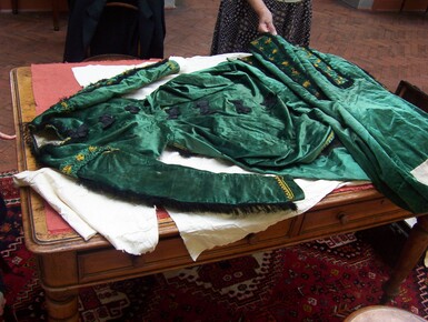A green velvet dress laid on a table