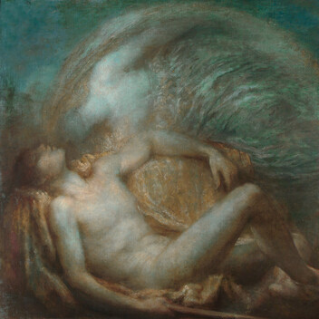 A man reclines with a woman leaning over him