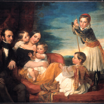 a couple posed with their four children around them