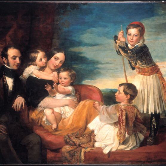 a couple posed with their four children around them