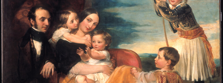 a couple posed with their four children around them