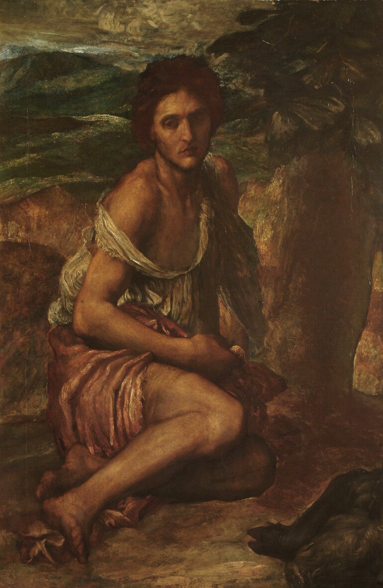 A man in rags sits in a rocky landscape
