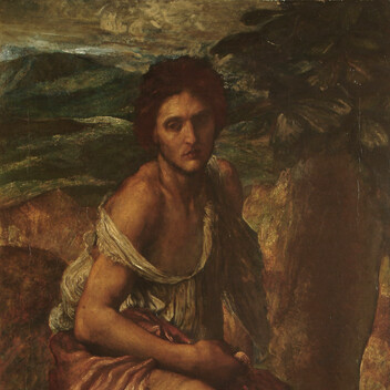 A man in rags sits in a rocky landscape