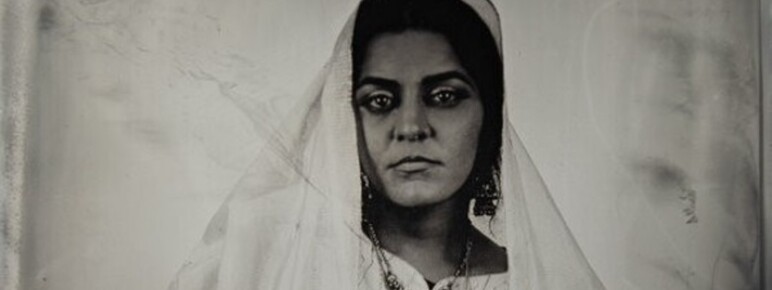 A dark Tintype photograph of a woman