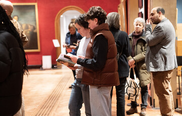 A photograph of a group of people inside the Historic Galleries during the opening of the exhibition of Faces of Fame