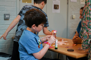 Boy making a flower from paper