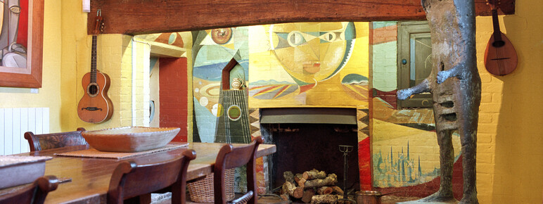 A photograph of the inside of Muddles Green featuring a colourful fireplace