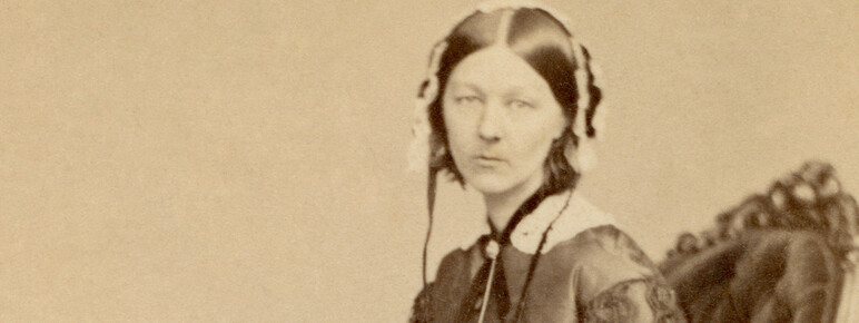 A sepia full body photo of Florence Nightingale seated