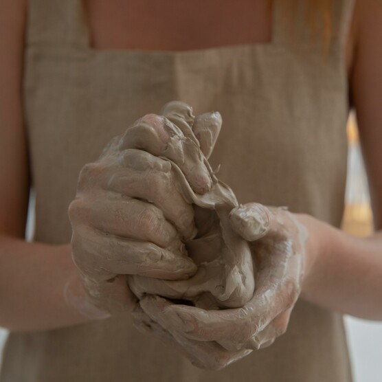 Close up of a pair of female hands working with clay