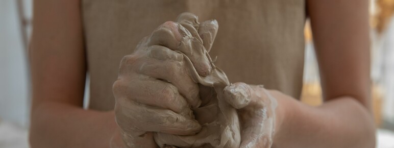 Close up of a pair of female hands working with clay