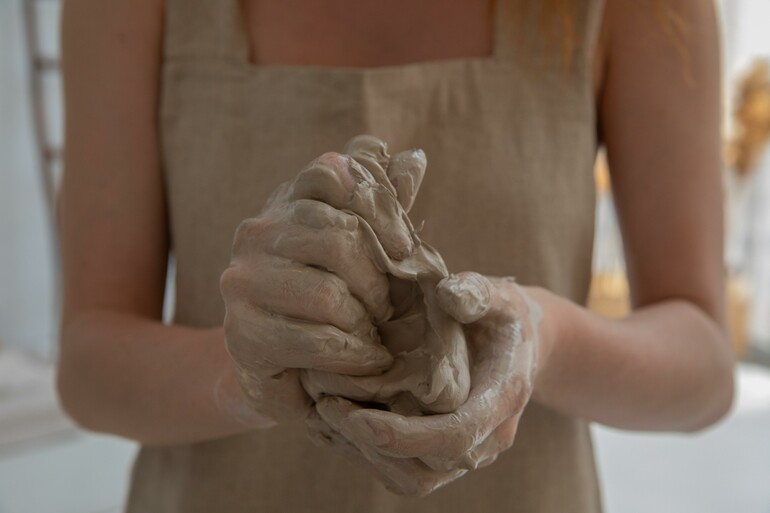 Close up of a pair of female hands working with clay