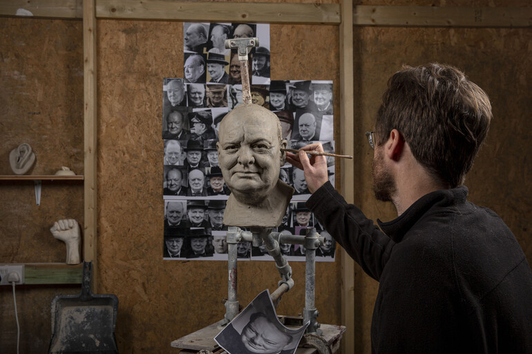Jethro Crabb in his studio sculpting the head of Winston Churchill