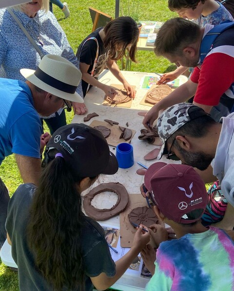 Children make clay tiles