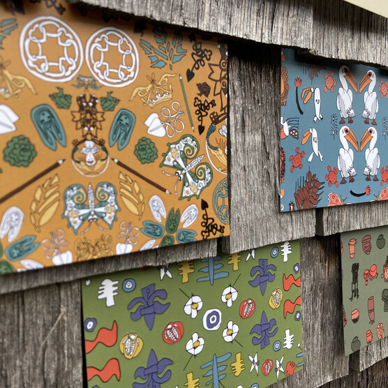 A collection of postcards containing a limner collection pattern inspired by the chapel are stuck into slats of wood, mimicking roof tiles