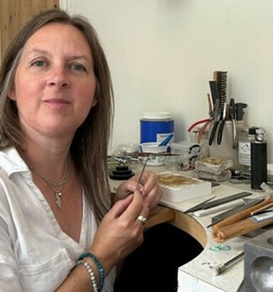 Photo of Kerry Tristram, an adult woman with brown hair, in her studio