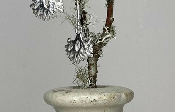 Photo of a pair of silver earrings that resemble plant roots