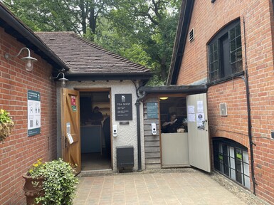 The Tea Shop entrance, the building is brick, the door is open.