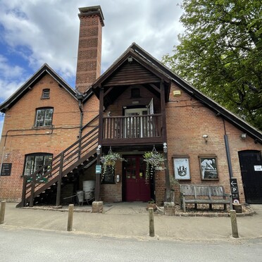 The visitor centre is a red brick building with an arched roof. There is a staircase along the side to allow access to a second story entrance