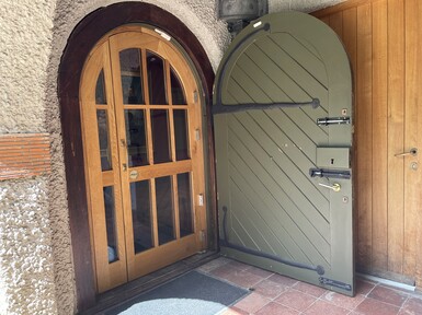 The door to the gallery is wooden with window panels