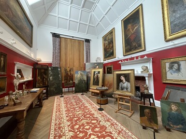 Artist studio filled with paintings on easels