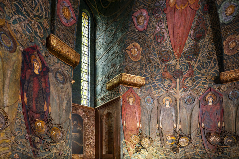 Interior of the chapel. Angels are depicted in rows and narrow windows let in some light.