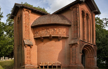 A terracotta celtic-style chapel with decorated tiles