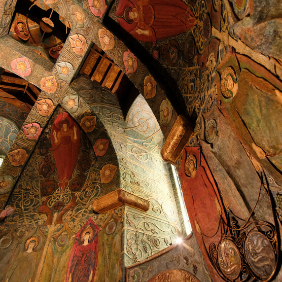 Highly decorate Watts Chapel ceiling interior with colourful symbolist panels