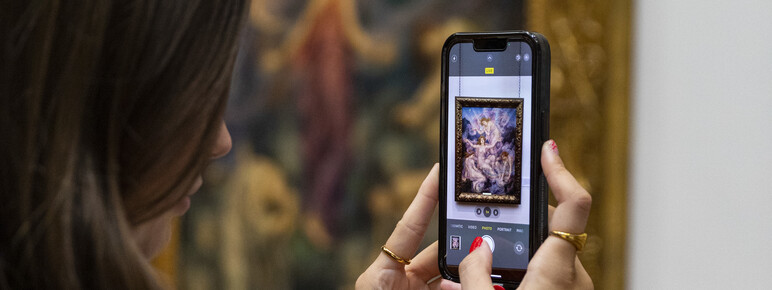 Women takes photo in De Morgan Gallery