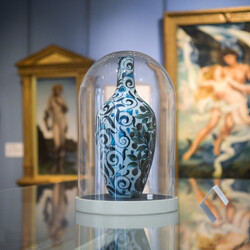 Vase in glass case in gallery