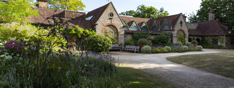 The outside of Watts Gallery with flower bed in foreground