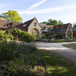 The outside of Watts Gallery with flower bed in foreground