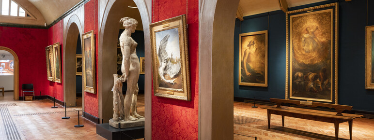 Inside of gallery with paintings and sculptures