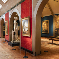 Inside of gallery with paintings and sculptures