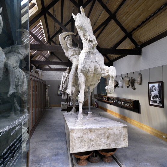 Large plaster sculpture of a man riding a horse, located in the Sculpture Gallery.