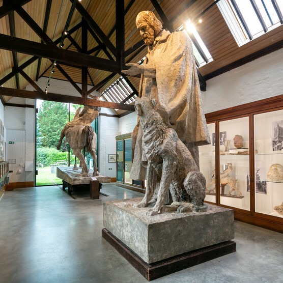 Sculpture gallery featuring large statue of Tennyson and dog