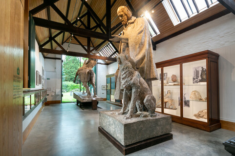 Sculpture gallery featuring large statue of Tennyson and dog