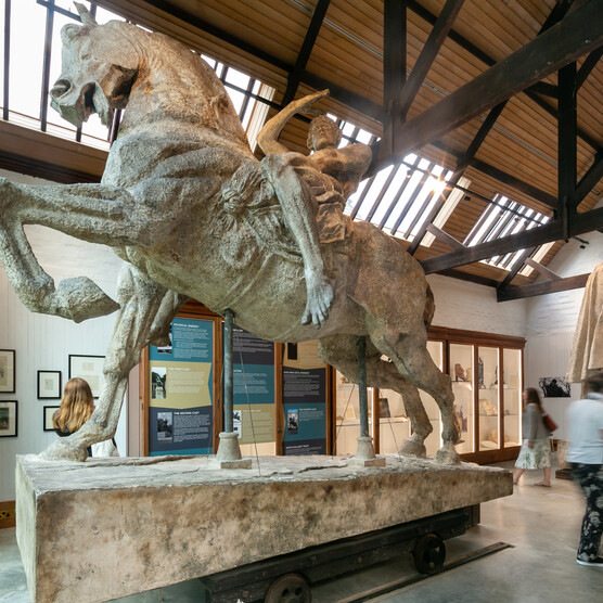 Large man on horse sculpture in gallery