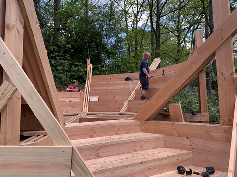 A builder works on wooden amphitheatre