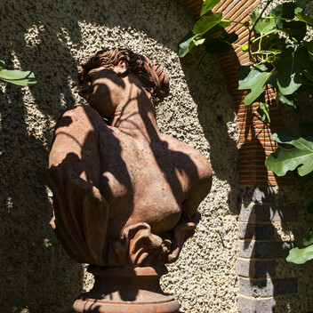 Terracotta sculpture of women's head turning to one side