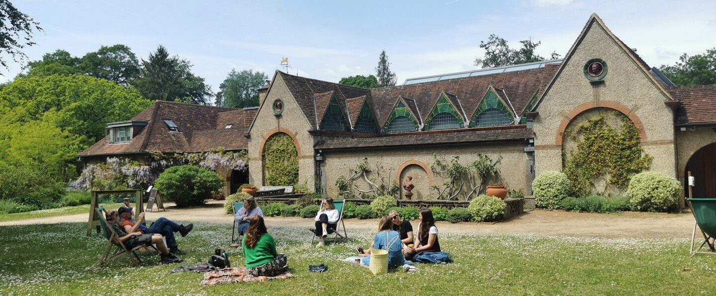 Group of people enjoying a picnic on the lawn outside the Historic Gallery