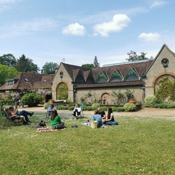 Group of people enjoying a picnic on the lawn outside the Historic Gallery