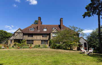 Blue sky with historic panelled house