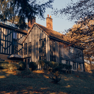 Black and white panelled building with trees
