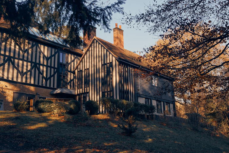 Black and white panelled building with trees