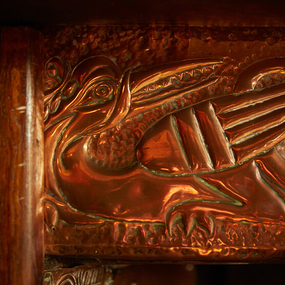 A close up of decorative fireplace in bronze