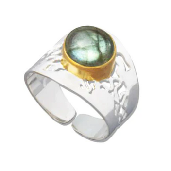 A silver band with a gold and blue stone forming a ring that was inspired by the starfish and seas of Indonesia