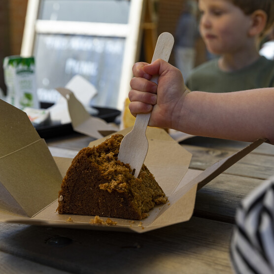 Child tucks into cake at Tea Shop