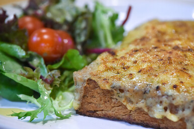 Close up of rarebit with side salad